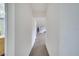 Neutral hallway leading to bathroom and bonus room areas, providing convenient access to the home's living spaces at 4394 Devon Ct, Kissimmee, FL 34746