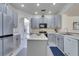 Spacious kitchen featuring modern appliances, gray cabinets, and a functional center island with ample counter space at 4394 Devon Ct, Kissimmee, FL 34746
