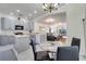 Open-concept kitchen boasts gray cabinets, a central island, and seamless flow into the dining and living areas at 4394 Devon Ct, Kissimmee, FL 34746