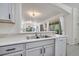 Bright kitchen showcases a stainless steel sink and view of an open floor plan to the living area at 4394 Devon Ct, Kissimmee, FL 34746