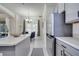 Well-lit kitchen showcases gray cabinets, sleek appliances, and an open view into the dining area at 4394 Devon Ct, Kissimmee, FL 34746