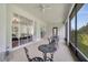 Spacious outdoor seating area with a screen enclosure, views of the landscaped yard and a ceiling fan at 4394 Devon Ct, Kissimmee, FL 34746