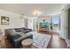 Spacious living room with hardwood floors, large sectional sofa, and media center at 4394 Devon Ct, Kissimmee, FL 34746