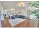 Open-concept living space with hardwood floors, a modern sectional, and view of dining room at 4394 Devon Ct, Kissimmee, FL 34746