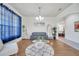 Cozy living room with stylish decor, hardwood floors, and blue sheer curtains at 4394 Devon Ct, Kissimmee, FL 34746