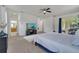 Comfortable main bedroom boasting neutral colors, sliding glass doors to the lanai, and a ceiling fan at 4394 Devon Ct, Kissimmee, FL 34746