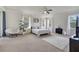 Spacious main bedroom featuring a plush rug, modern ceiling fan, and ample natural light from multiple windows at 4394 Devon Ct, Kissimmee, FL 34746