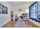Bright office featuring hardwood floors, workstation, and a blue curtain at 4394 Devon Ct, Kissimmee, FL 34746