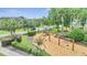 Community playground with swings, slides, and green landscaping providing a fun outdoor space for residents at 4394 Devon Ct, Kissimmee, FL 34746
