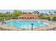 Community pool with lounge chairs and a covered pavilion, providing a relaxing outdoor space at 4394 Devon Ct, Kissimmee, FL 34746