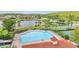 Large community pool with lounge chairs and a lake view provides a relaxing outdoor amenity at 4394 Devon Ct, Kissimmee, FL 34746