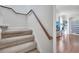Staircase leading to the main level, featuring hardwood floors and a view of the bright entryway at 4394 Devon Ct, Kissimmee, FL 34746