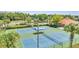 Well-maintained tennis courts surrounded by lush greenery and palm trees enhance the community's recreational appeal at 4394 Devon Ct, Kissimmee, FL 34746