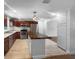 Bright kitchen with stainless steel appliances, dark wood cabinets, and an island at 520 Sumner Ave, Orange City, FL 32763