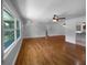 Bright living room with large windows and gleaming hardwood floors at 520 Sumner Ave, Orange City, FL 32763
