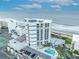 A stunning beachfront condo tower in an aerial view near the tennis court and pool at 5207 S Atlantic Ave # 225, New Smyrna Beach, FL 32169