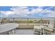Relaxing balcony with ocean view, comfortable seating and a table for outdoor dining at 5207 S Atlantic Ave # 225, New Smyrna Beach, FL 32169