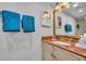 Charming bathroom featuring a granite countertop and antique gold fixtures at 5207 S Atlantic Ave # 225, New Smyrna Beach, FL 32169