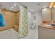 Well-lit bathroom showcasing a tiled shower, a comfort height toilet and a granite countertop vanity at 5207 S Atlantic Ave # 225, New Smyrna Beach, FL 32169