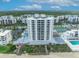 A beachfront condominium complex featuring a pristine white exterior, private balconies, and oceanfront pool and beach access at 5207 S Atlantic Ave # 225, New Smyrna Beach, FL 32169