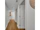 Hallway with wood flooring, white walls, and a door ajar at 5207 S Atlantic Ave # 225, New Smyrna Beach, FL 32169