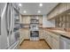 Kitchen with stainless steel appliances, light-colored cabinets and granite countertops at 5207 S Atlantic Ave # 225, New Smyrna Beach, FL 32169