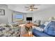 Comfortable living space with ocean views, beachy furniture, and a flat screen television at 5207 S Atlantic Ave # 225, New Smyrna Beach, FL 32169