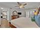 Bright bedroom with wood floors, access to balcony with shutters, and a TV at 5207 S Atlantic Ave # 225, New Smyrna Beach, FL 32169