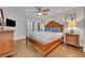 Spacious bedroom featuring wood floors, a ceiling fan, and a glass door to the balcony at 5207 S Atlantic Ave # 225, New Smyrna Beach, FL 32169