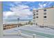 Relaxing view of the ocean from a balcony with a pool deck and shuffleboard court at 5207 S Atlantic Ave # 225, New Smyrna Beach, FL 32169