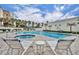 Resort-style pool with lounge chairs, lush landscaping, and a sunny ambiance at 5207 S Atlantic Ave # 225, New Smyrna Beach, FL 32169