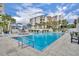 Large rectangular pool with comfortable seating, palm trees, and resort style living at 5207 S Atlantic Ave # 225, New Smyrna Beach, FL 32169