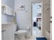 Bright bathroom featuring a white vanity, toilet and coastal-themed decorations at 528 Terra Lago St, Davenport, FL 33897