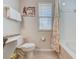 Bathroom featuring shower-tub combo, granite countertop, and neutral wall color at 528 Terra Lago St, Davenport, FL 33897