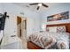Comfortable bedroom with a ceiling fan, complemented by tasteful decor and natural light, creating a relaxing retreat at 528 Terra Lago St, Davenport, FL 33897