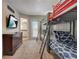 Bedroom featuring carpeted floors, bunkbeds, and sliding glass doors to a balcony at 528 Terra Lago St, Davenport, FL 33897