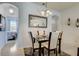 Cozy dining area featuring modern light fixture and decor, offering a view into the adjacent bedroom at 528 Terra Lago St, Davenport, FL 33897