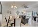 Elegant dining area with modern lighting and stylish decor, adjacent to the living room, ideal for Gathering gatherings at 528 Terra Lago St, Davenport, FL 33897