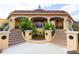 Stairway to a building featuring an orange facade, arched entryways, and decorative landscaping at 528 Terra Lago St, Davenport, FL 33897