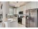 Contemporary kitchen with white cabinets, stainless steel appliances, and granite countertops, perfect for the modern home at 528 Terra Lago St, Davenport, FL 33897