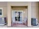 Covered patio with seating and sliding glass doors, offering an outdoor living space at 528 Terra Lago St, Davenport, FL 33897