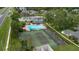 Aerial view of complex amenities with pool, tennis courts, and lovely landscaping at 5635 Blue Shadows Ct # 3, Orlando, FL 32811