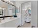 Bathroom featuring white countertops and cabinetry and a framed mirror over the sink at 5635 Blue Shadows Ct # 3, Orlando, FL 32811