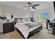 Well-lit bedroom featuring a comfortable bed, modern decor, a ceiling fan, and natural light at 5635 Blue Shadows Ct # 3, Orlando, FL 32811