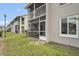 Building exterior with second story screened in porch and lush green lawn at 5635 Blue Shadows Ct # 3, Orlando, FL 32811