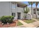 Well-maintained exterior with greenery, stairs, and a charming entrance with a decorative front door at 5635 Blue Shadows Ct # 3, Orlando, FL 32811