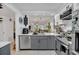 Modern kitchen with stainless steel appliances, gray cabinets, and an open view to the living area at 5635 Blue Shadows Ct # 3, Orlando, FL 32811