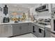 Modern kitchen featuring gray and white cabinetry, stainless steel appliances, and an open layout at 5635 Blue Shadows Ct # 3, Orlando, FL 32811