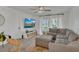 Comfortable living room featuring a sectional sofa, TV, and bright windows at 5635 Blue Shadows Ct # 3, Orlando, FL 32811