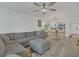 Open-concept living space with a sectional sofa, dining area, and lots of sunlight at 5635 Blue Shadows Ct # 3, Orlando, FL 32811